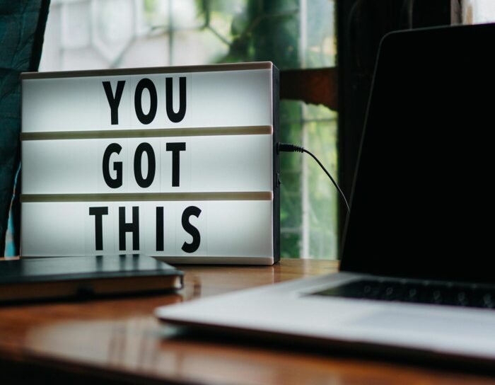 Sign next to a laptop that says "YOU GOT THIS"